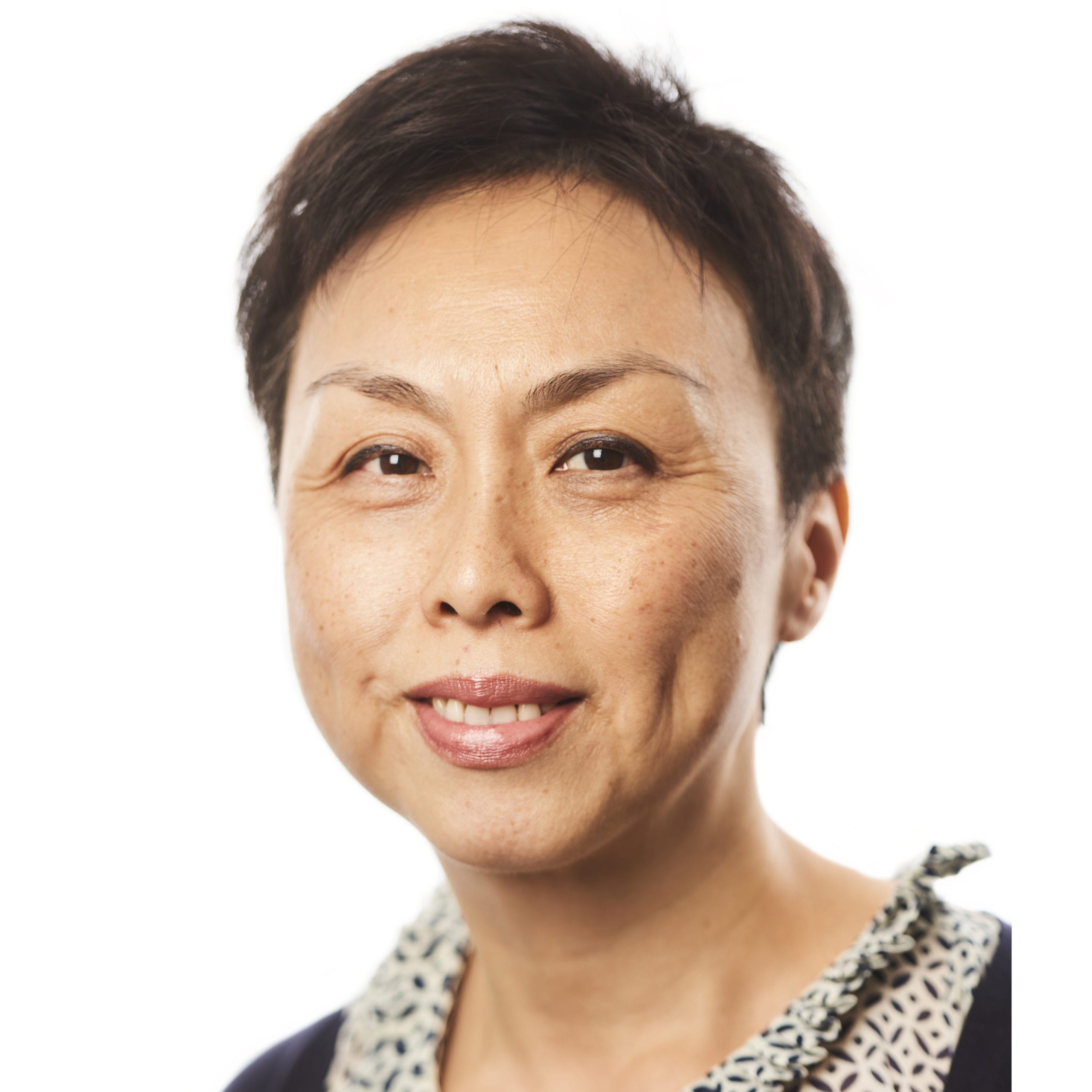 Headshot of Sandra Chung, with short brown hair, wearing a black and white blouse.