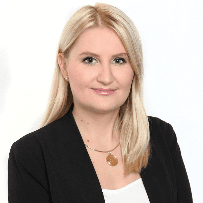 Headshot of Diana Fetchel with blonde hair and wearing a black suit.