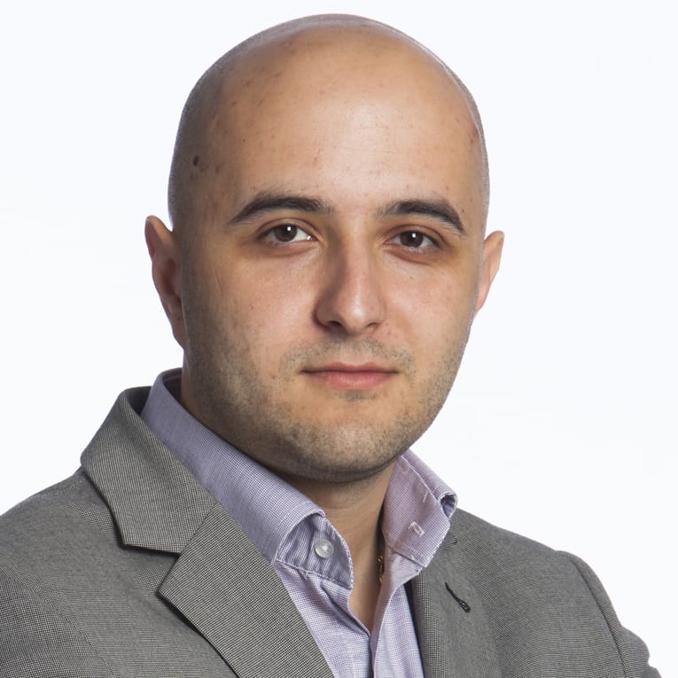 Headshot of Grzegorz Klimczyk wearing a grey suit.