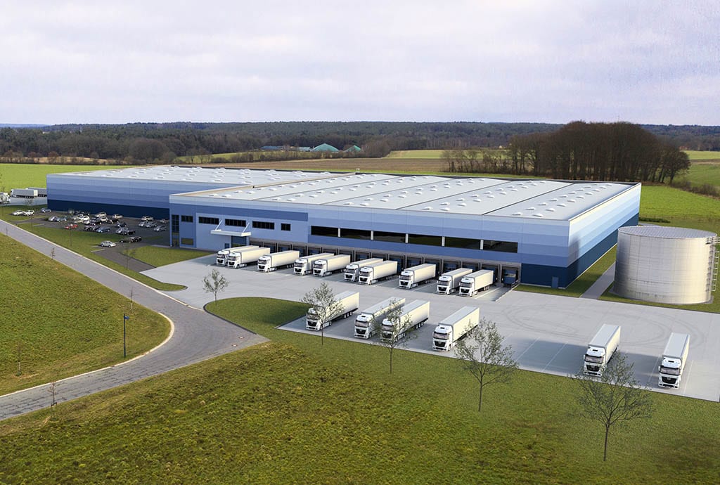 GLP Logistics Centre in Hamburg, surrounded by grass fields, where multiple vehicles dock in the loading bays.