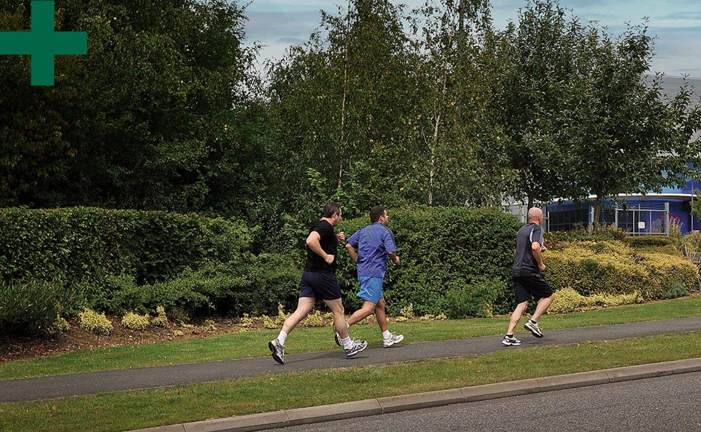 Men jogging on the pavement.